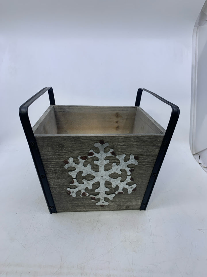 GREY PLANTER W/ GALVANIZED METAL SNOWFLAKE BLACK HANDLES.