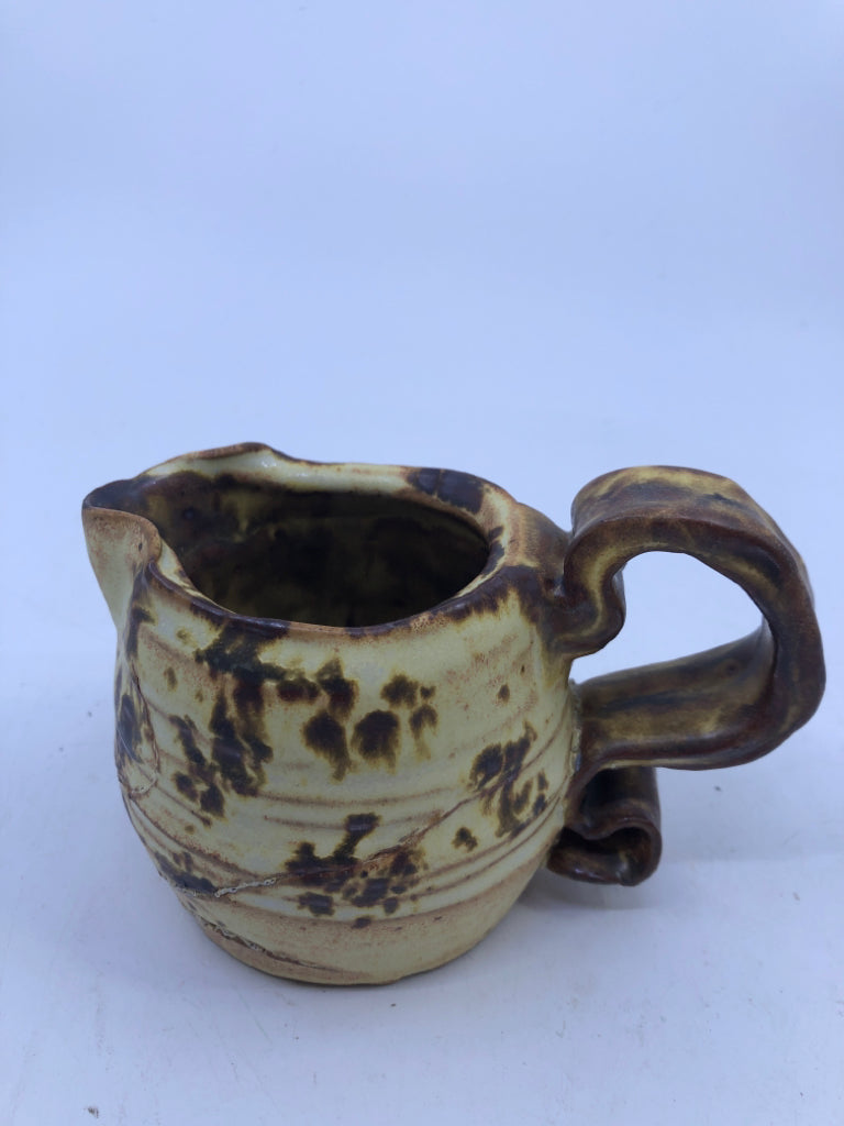 BROWN AND YELLOW COW PATTERN CREAMER.