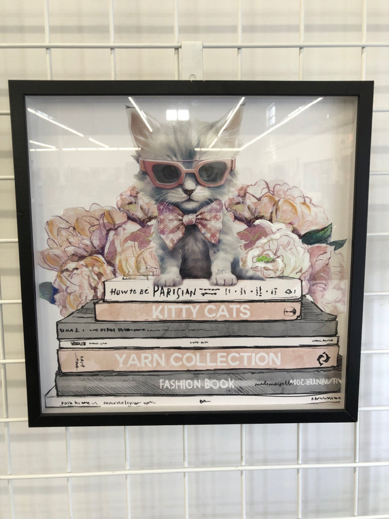 WHITE KITTY CAT IN PINK SUNGLASSES IN BLACK FRAME.