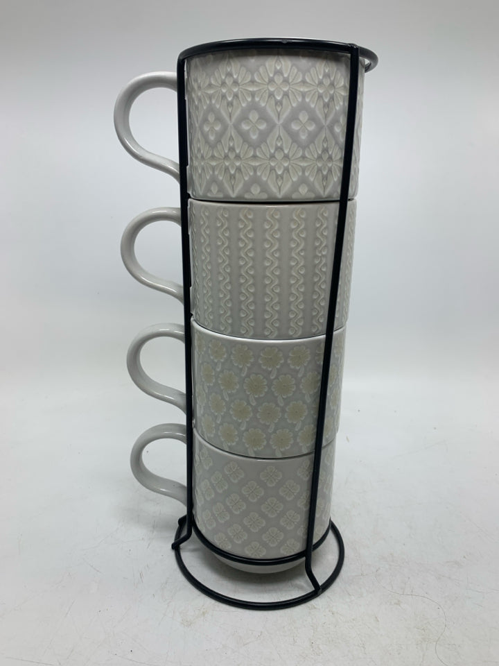 4 STACKING EMBOSSED MUGS IN STAND.