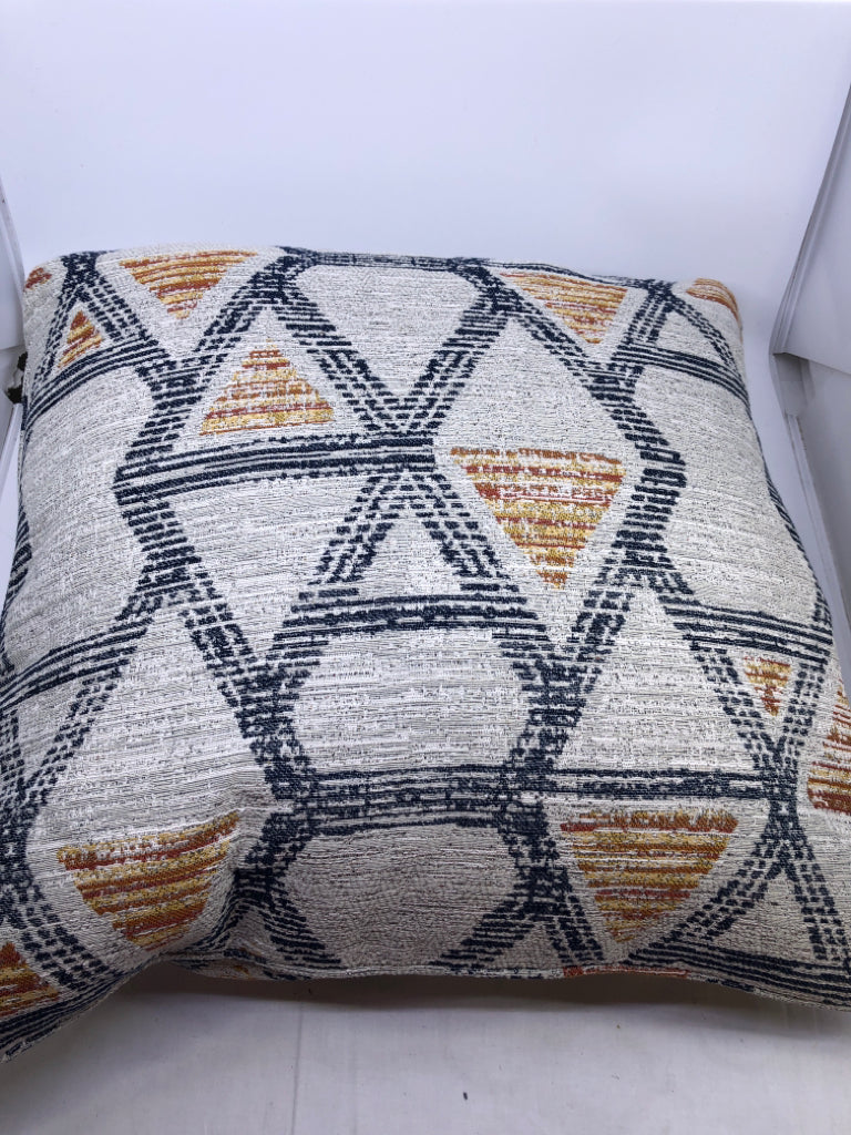 GREY ACCENT PILLOW W ORANGE AND NAVY BLUE ACCENTS.