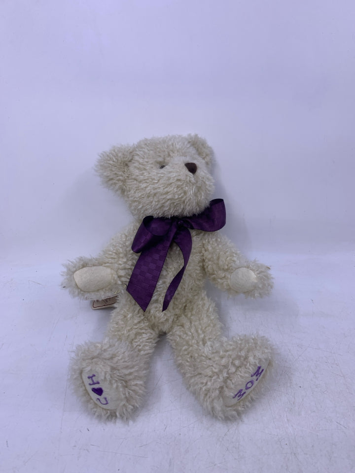 SCRUFFY WHITE BEAR W/ PURPLE BOW.