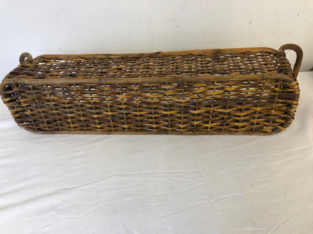 LONG WOVEN WICKER BASKET W/ DOUBLE HANDLES.