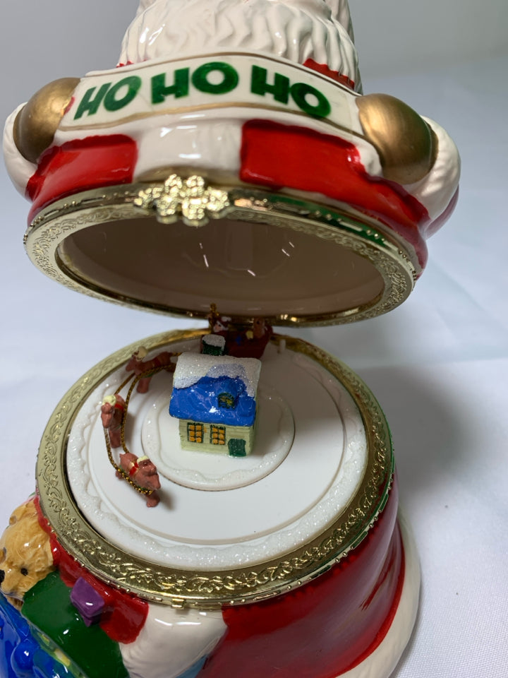CERAMIC SANTA MUSIC BOX W/ REINDEER PULLING SLAY INSIDE.