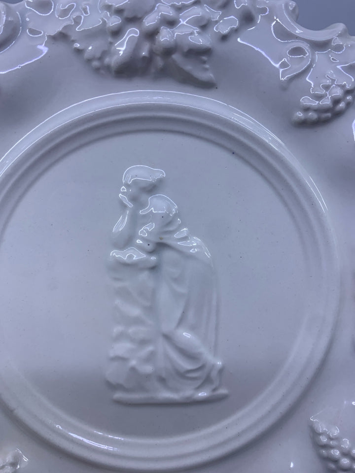 VTG EMBOSSED PLATE W WOMAN ON FRONT.