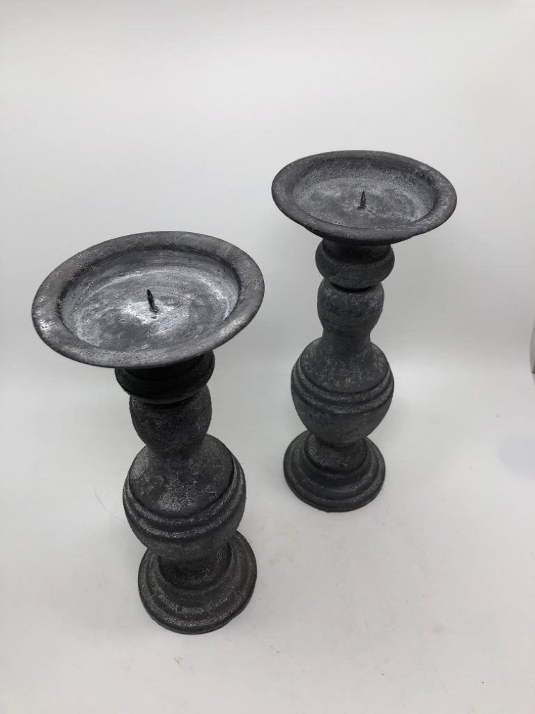 2 GREY METAL CANDLESTICK HOLDERS.