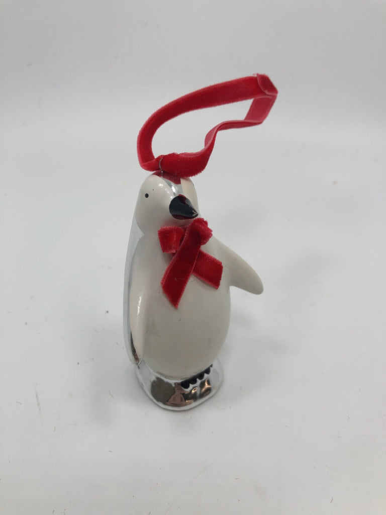 SILVER PENGUIN W/RED BOW ORNAMENT.