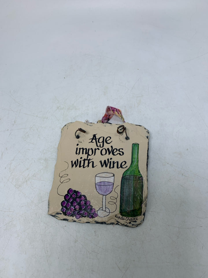 SMALL PAINTED AGE IMPROVES W/ WINE STONE SLATE WALL HANGING.