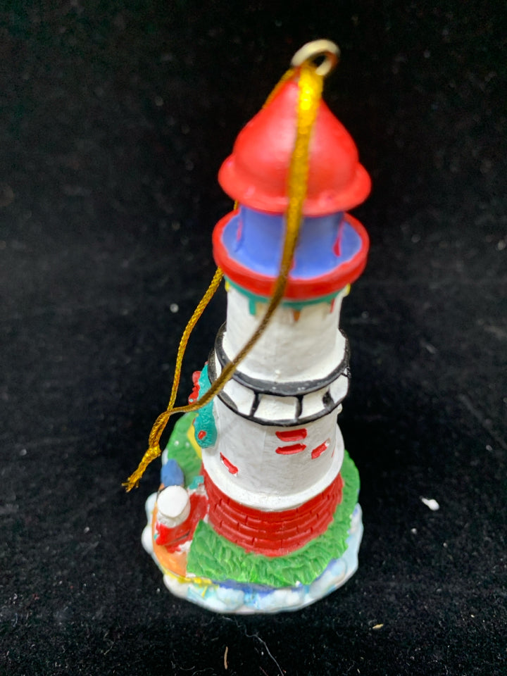 WHITE LIGHTHOUSE ORNAMENT W/SAILING SANTA.