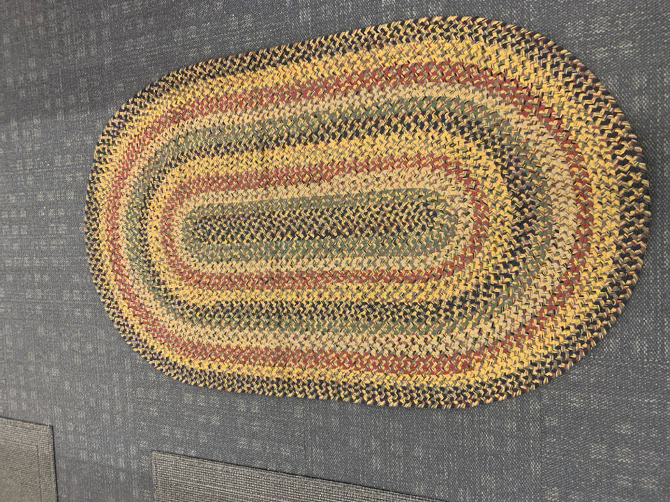 OVAL BRAIDED RUG.