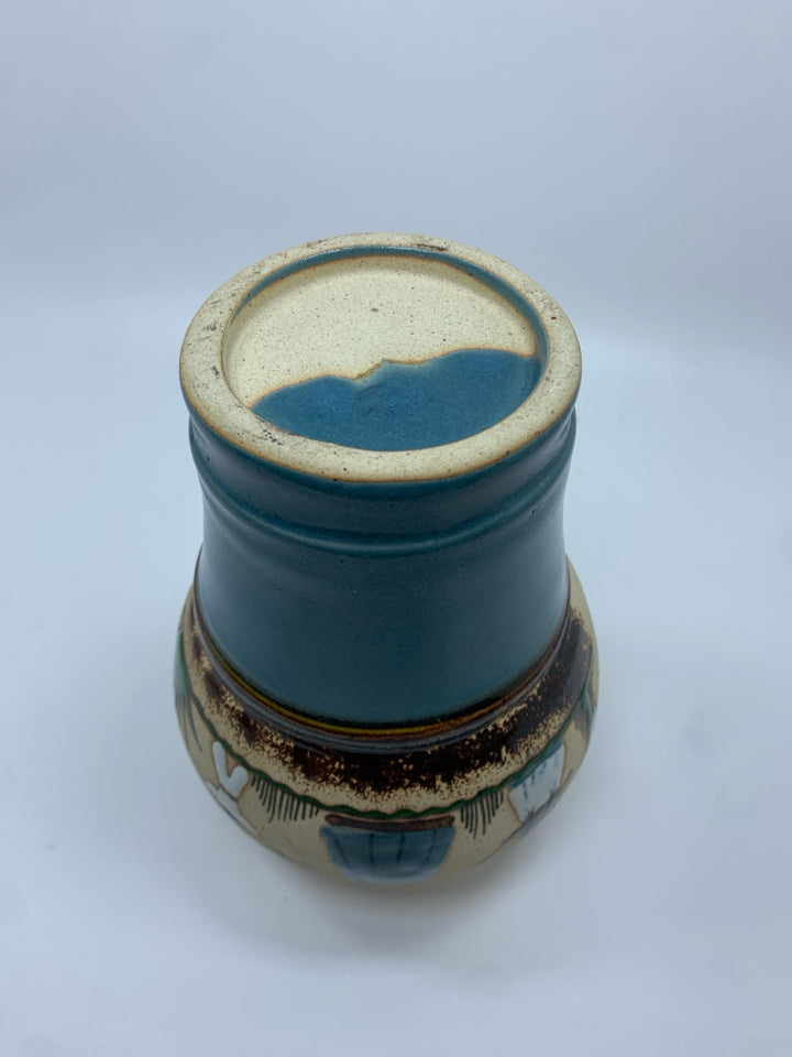 MOTHER AND CHILDREN TEAL GLAZED POTTERY VASE.