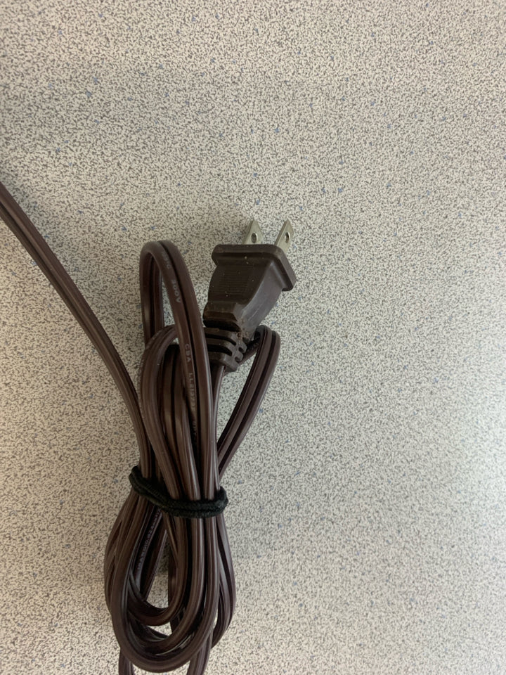 BLACK SCROLL BASE LAMP W/GOLD FLECKS AND TAN SHADE.