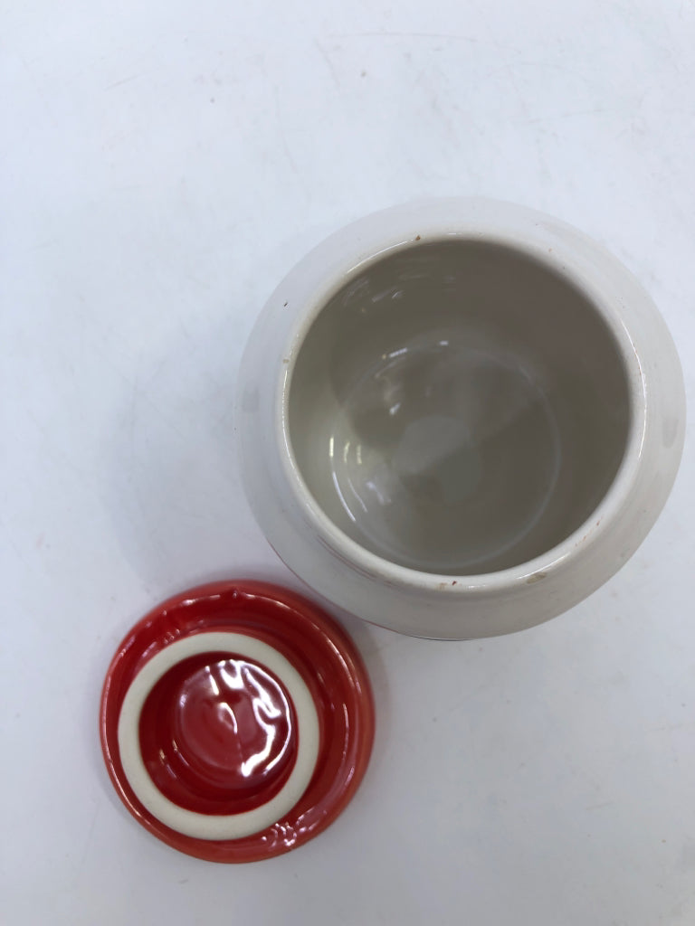 SMALL WHITE AND BLACK CANISTER W/ RED LID.