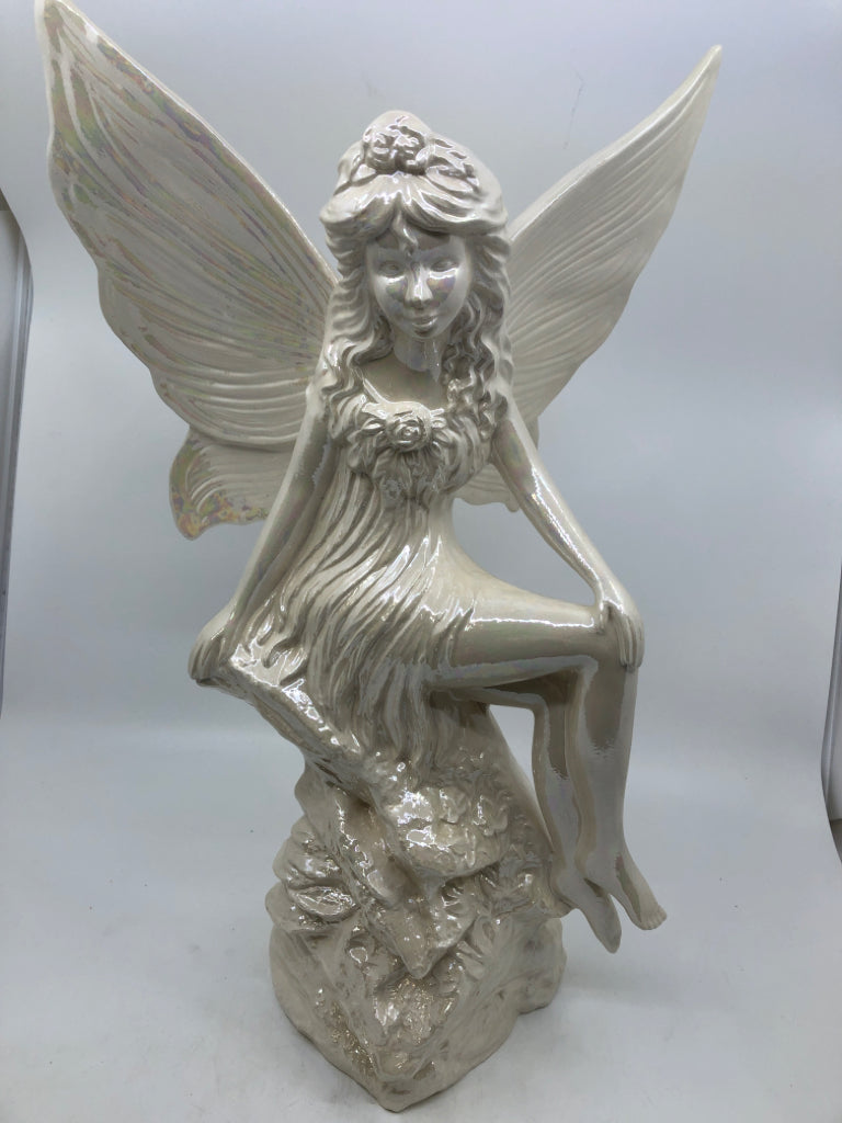 LARGE IRIDESCENT FAIRY SITTING ON A ROCK CERAMIC.