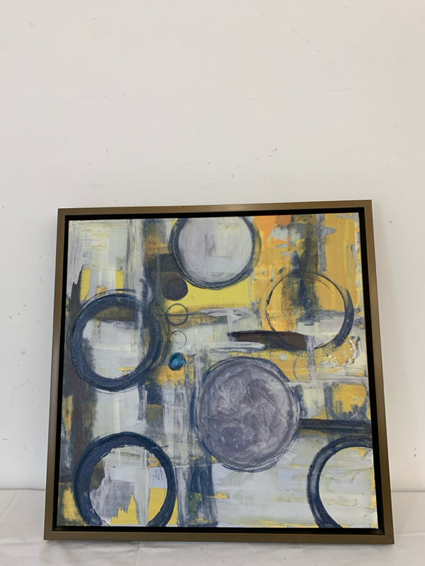 BLUE AND YELLOW CIRCLE ABSTRACT WALL HANGING IN BROWN FRAME.