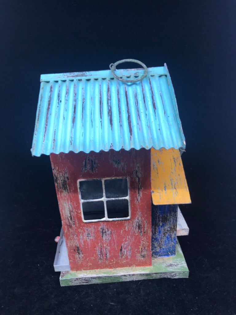 MULTI COLORED TIN BIRD HOUSE W/ PULL OUT TRAY/HEART CUT OUT.