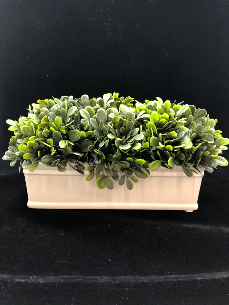 FAUX GREENS IN WHITE CERAMIC PLANTER.