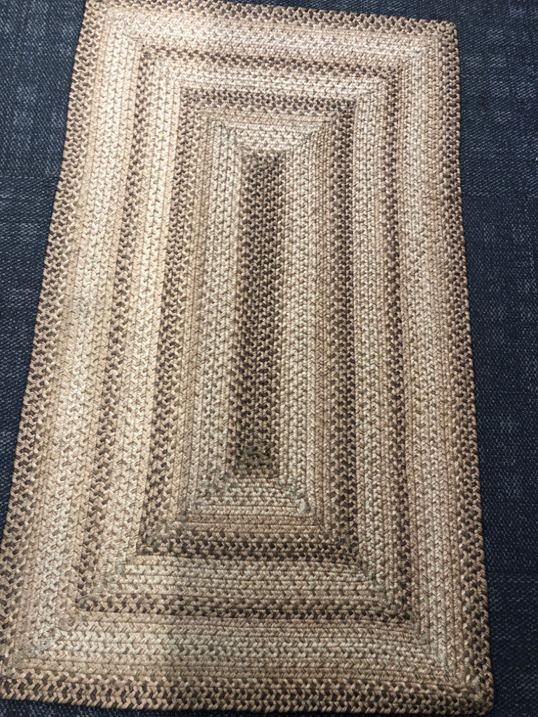 BROWN BRAIDED RECTANGLE AREA RUG.