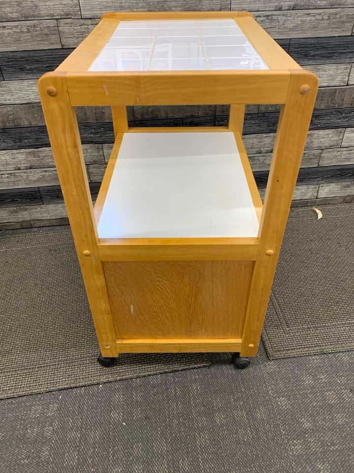 ROLLING KITCHEN CART BLONDE WOOD & WHITE W/TILE COUNTER TOP & 2 DOORS.