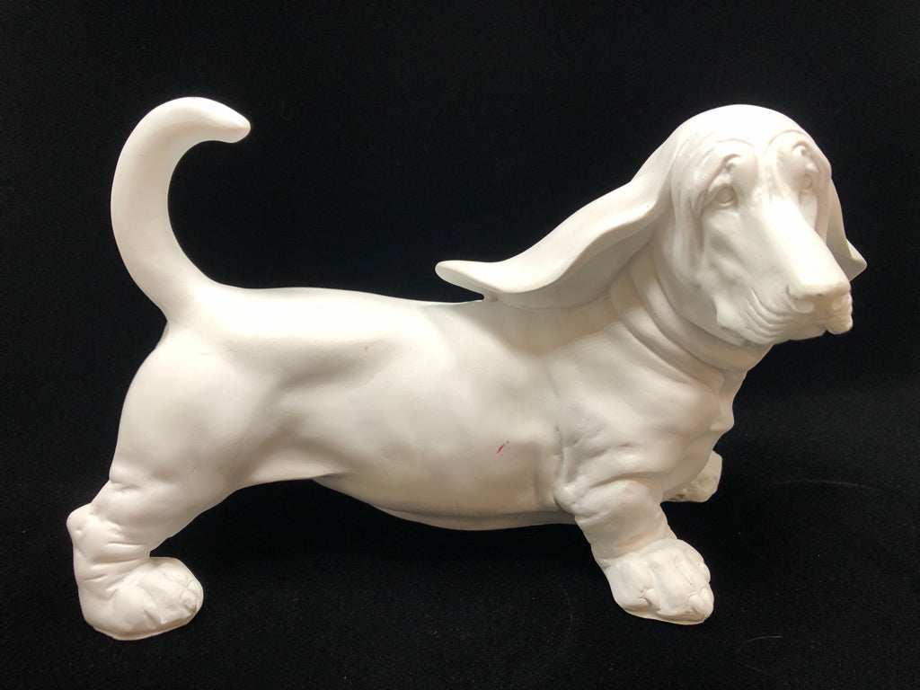 WHITE CERAMIC DOG FIGURINE.