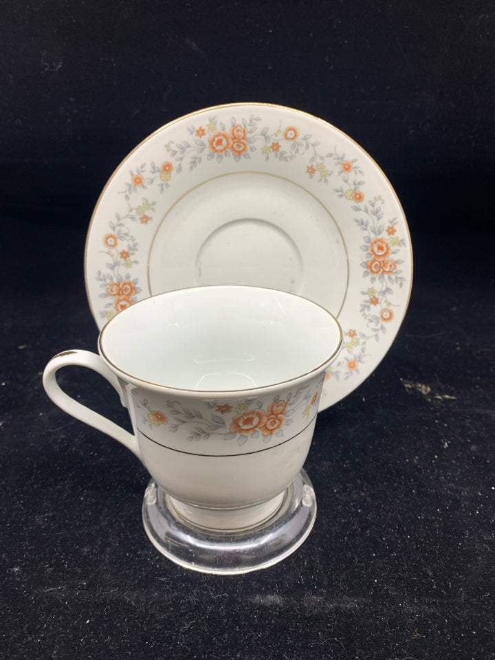 ORANGE AND BLUE FLORAL TEA CUP AND SAUCER.