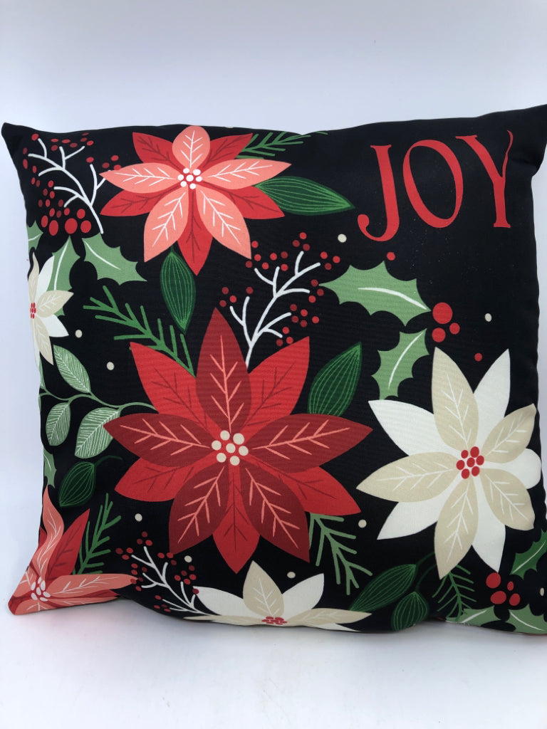 JOY BLACK ACCENT PILLOW WITH DECORATIVE FLOWERS.