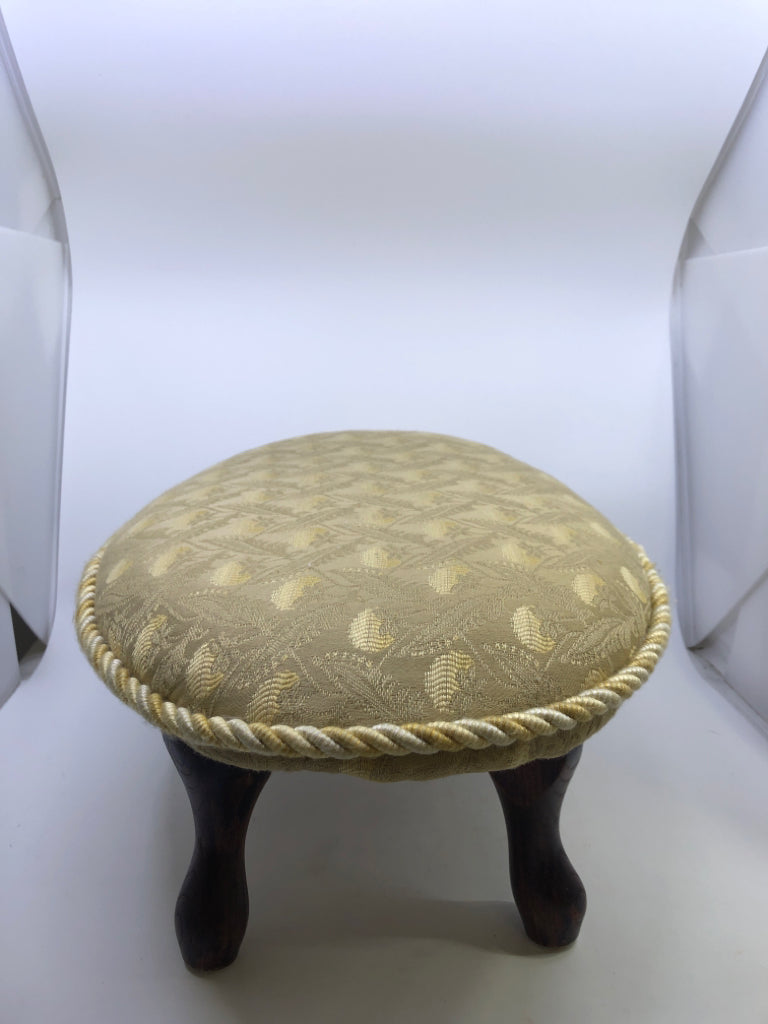 YELLOW FOOT REST FLORAL PATTERN W/TWISTED CHORD EDGE & DARK WOOD FEET.