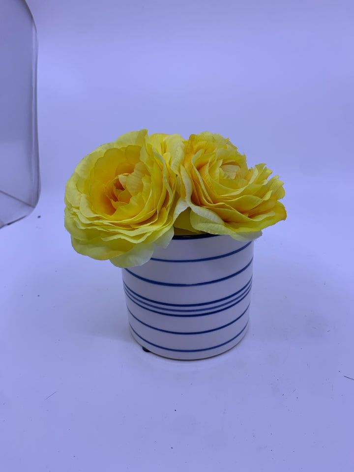 YELLOW FLORAL IN BLUE AND WHITE VASE.