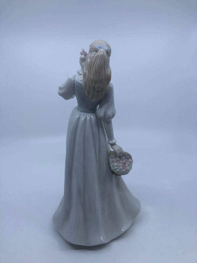 LADY W/BASKET OF FLOWERS PORCELAIN FIGURINE.