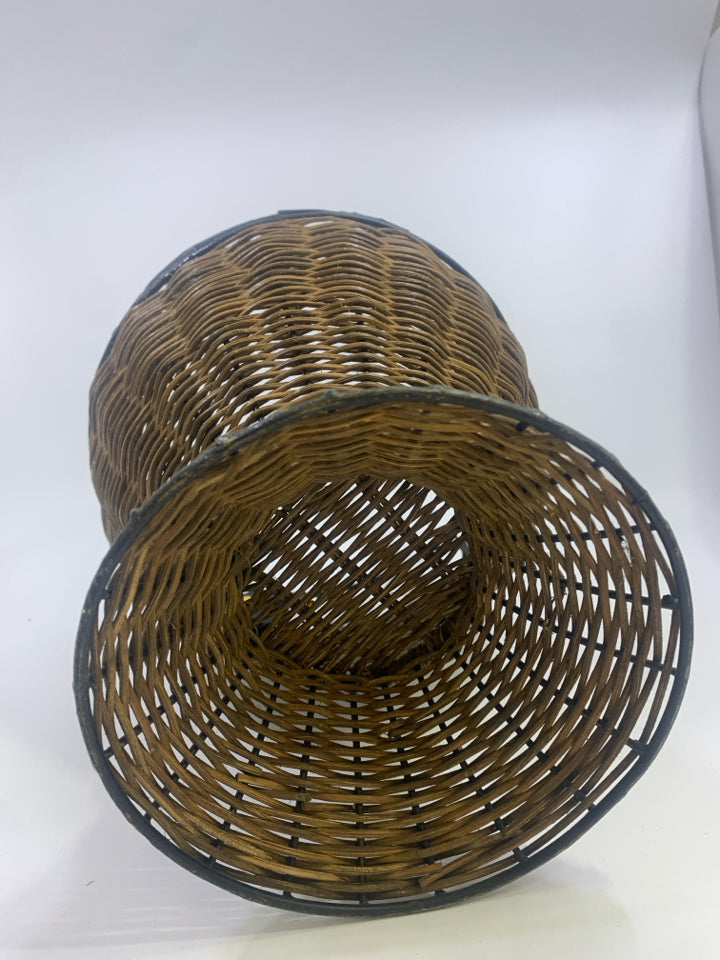 METAL SCROLL AND WICKER PLANTER BASKET W/LEAF DETAILS.