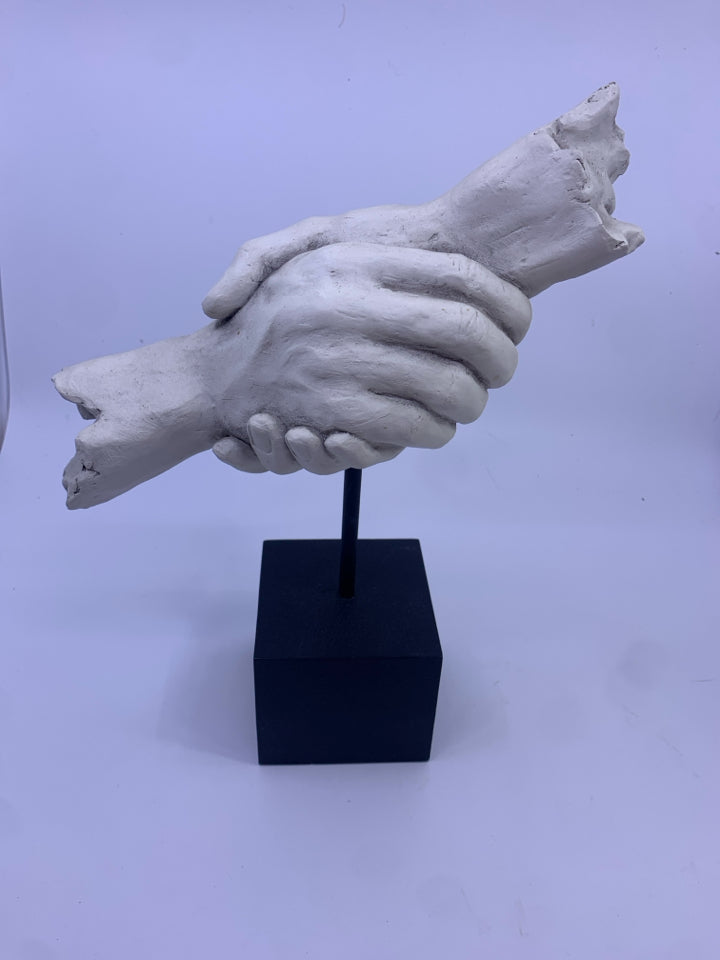 HOLDING HANDS ON HEAVY METAL BLOCK SHELF DECOR.