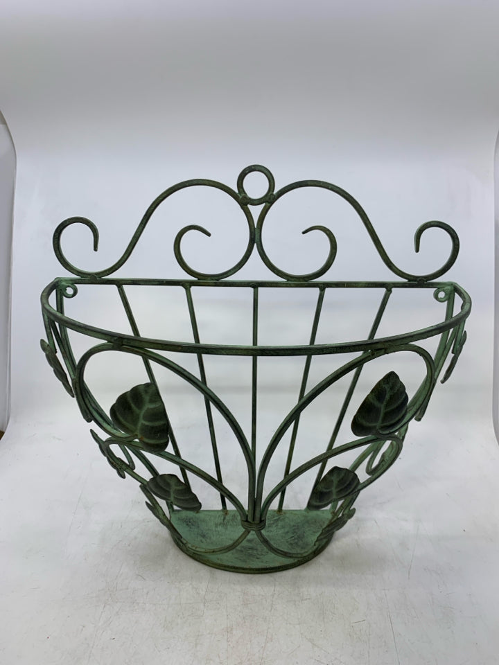 GREEN METAL WALL POCKET W/ LEAVES.
