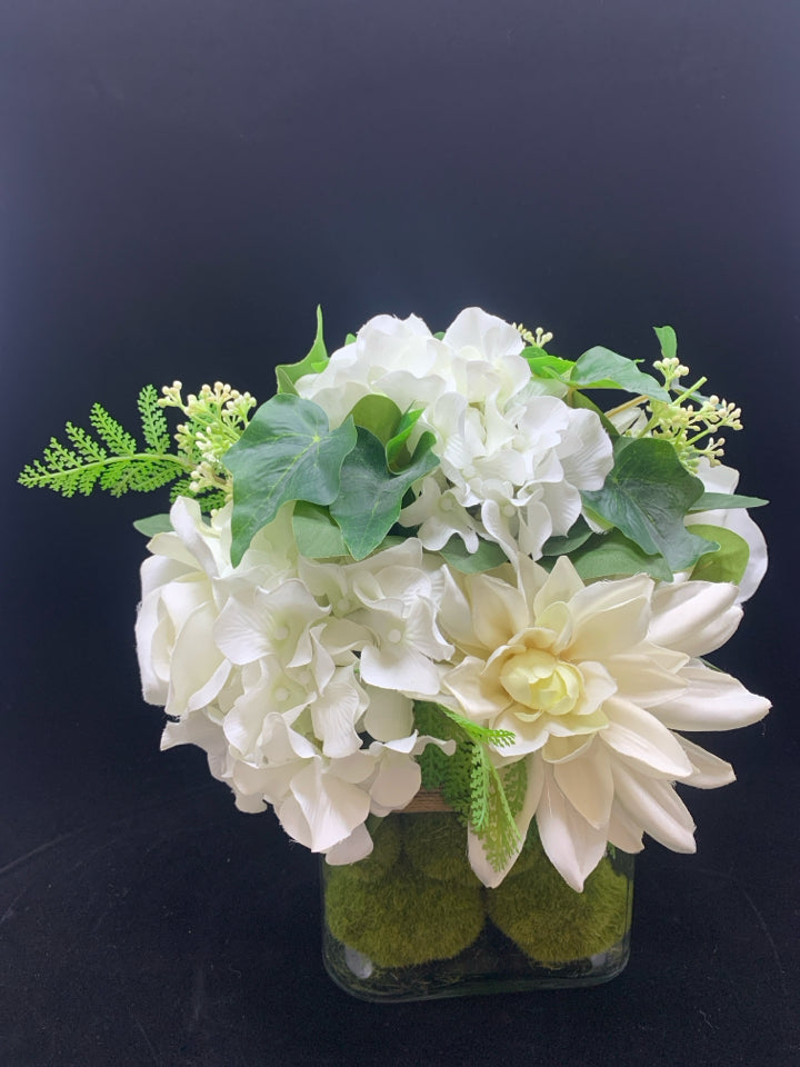 WHITE FLOWERS IN SQUARE GLASS VASE.