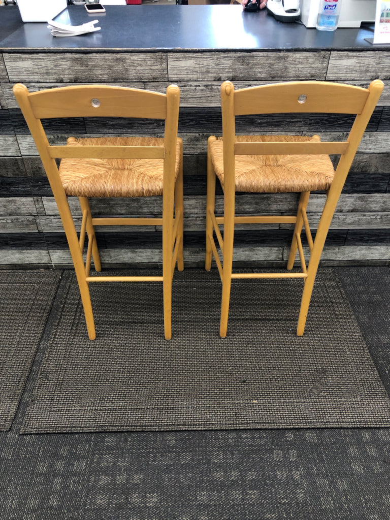 2 BLONDE BAR STOOLS W/ WICKER SEATS.