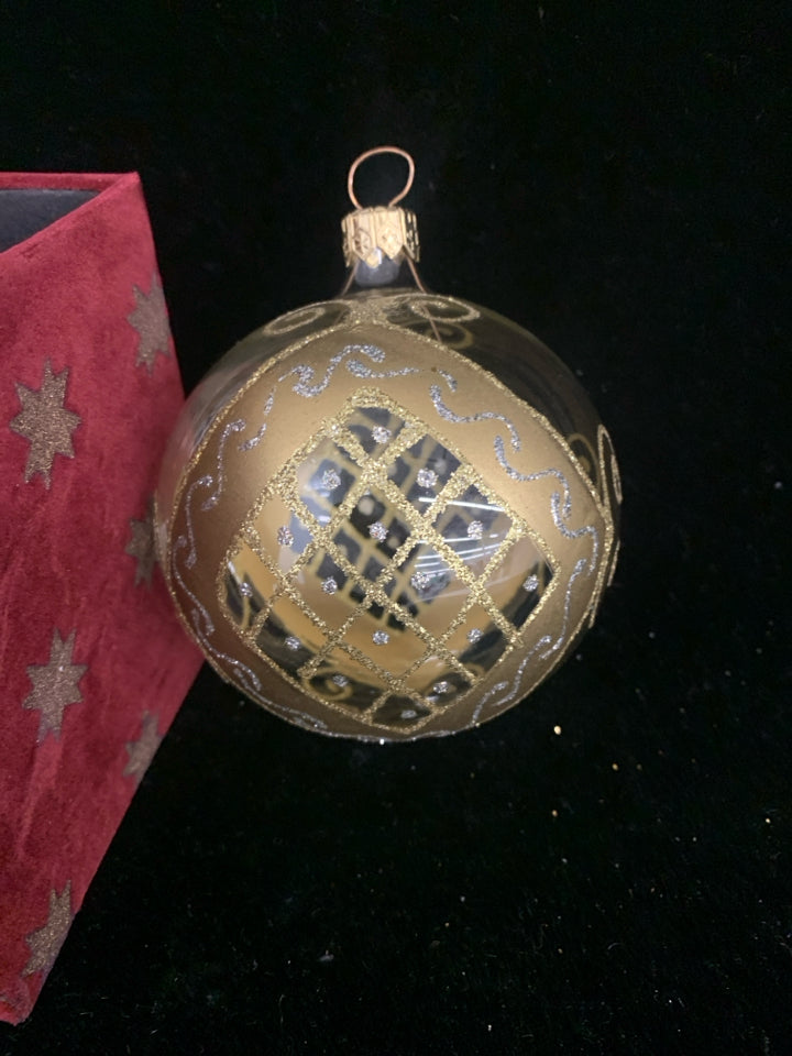 GOLD ACCENT GLASS ORNAMENT IN RED BOX.