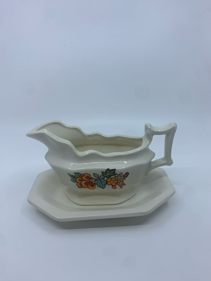 CREAM W ORANGE FLORAL GRAVY BOAT AND PLATE.