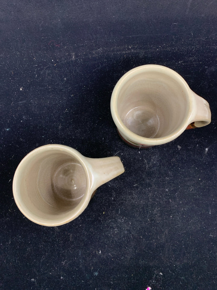 2 POTTERY MUGS W/ GRAY,DARK BROWN, RED BOTTOM W/ LEAF.