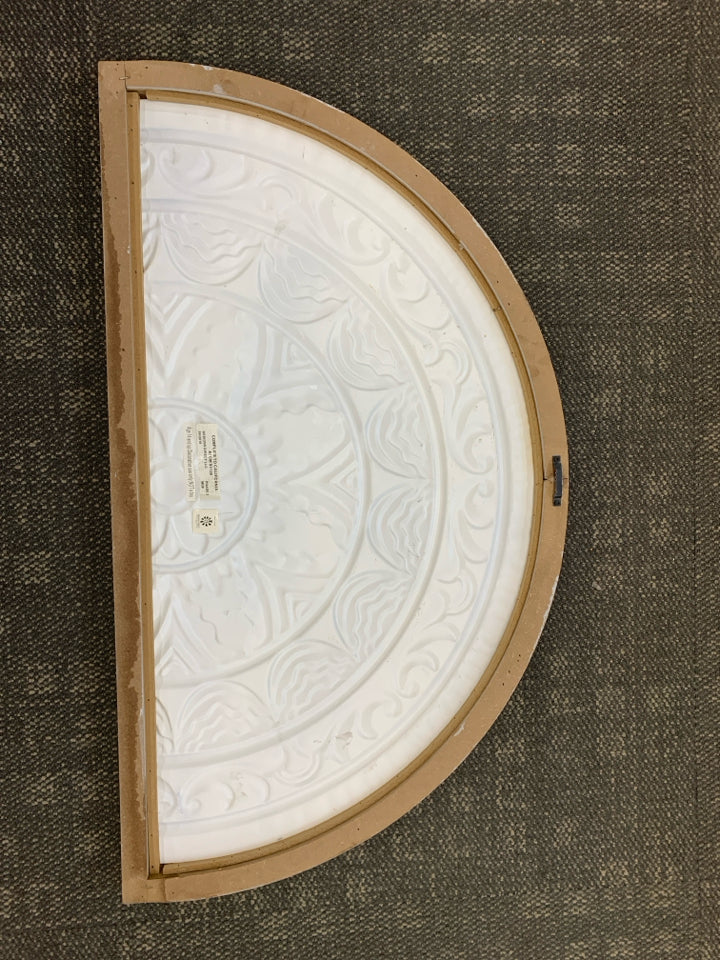 DISTRESSED HALF-CIRCLE METAL MEDALLION.