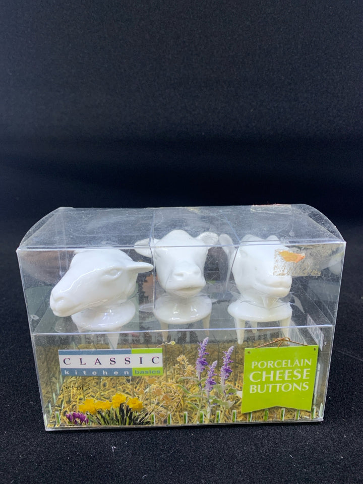 NIB COW PORCELAIN CHEESE BUTTONS.