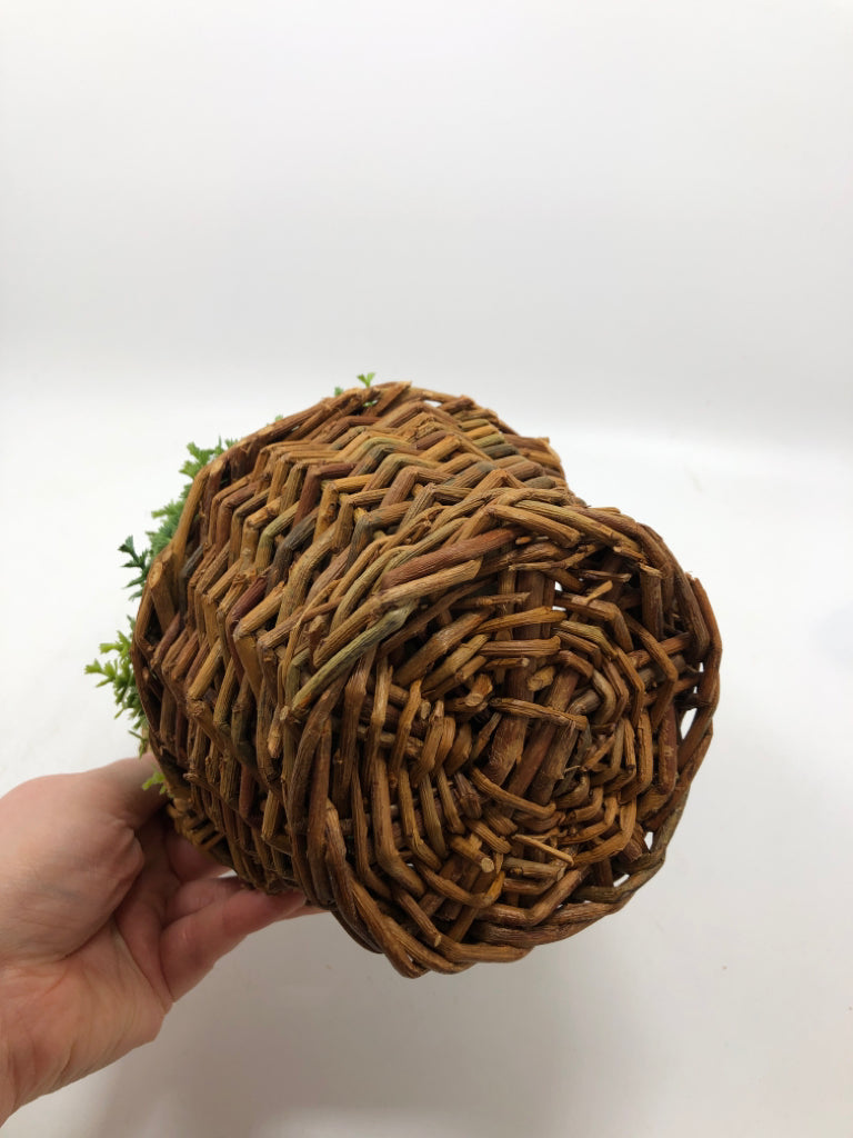 FAUX GREENERY IN HANGING WICKER BASKET.