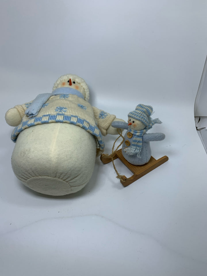 PLUSH WEIGHTED SNOWMAN PULLING BABY.