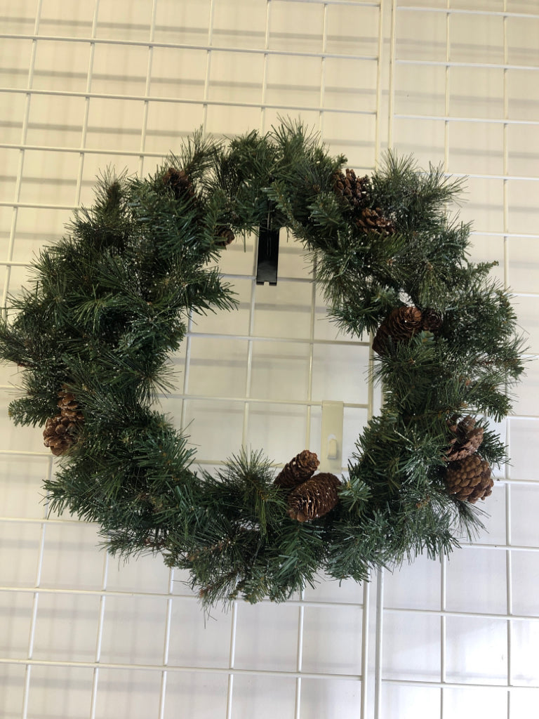 PINE WREATH W/PINECONES AND FAUX SNOW.
