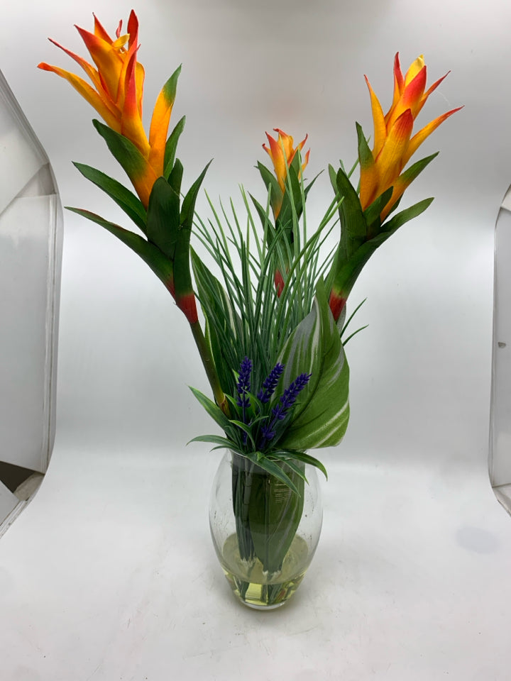 FAUX TROPICAL FLOWER IN CLEAR VASE.