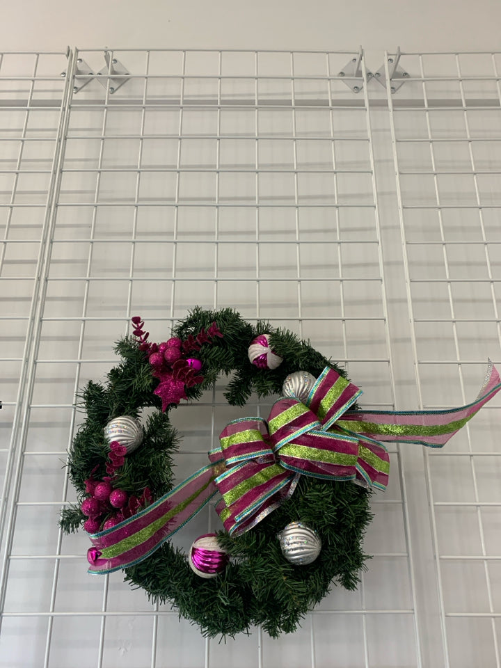 LARGE WREATH W ORNAMENTS AND PINK AND GREEN BOW.