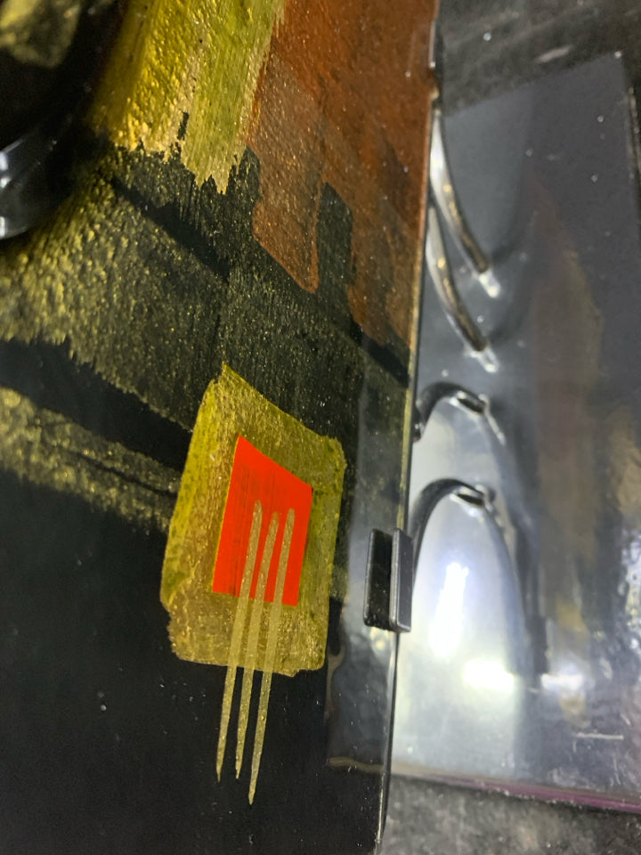 BLACK METAL THIN VASE W/GOLD ACCENTS.