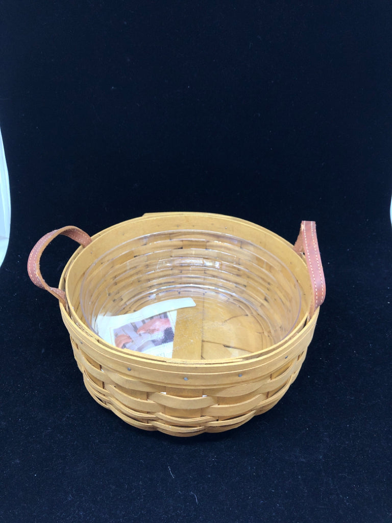 ROUND BASKET W PLASTIC LINER AND LEATHER HANDLES.