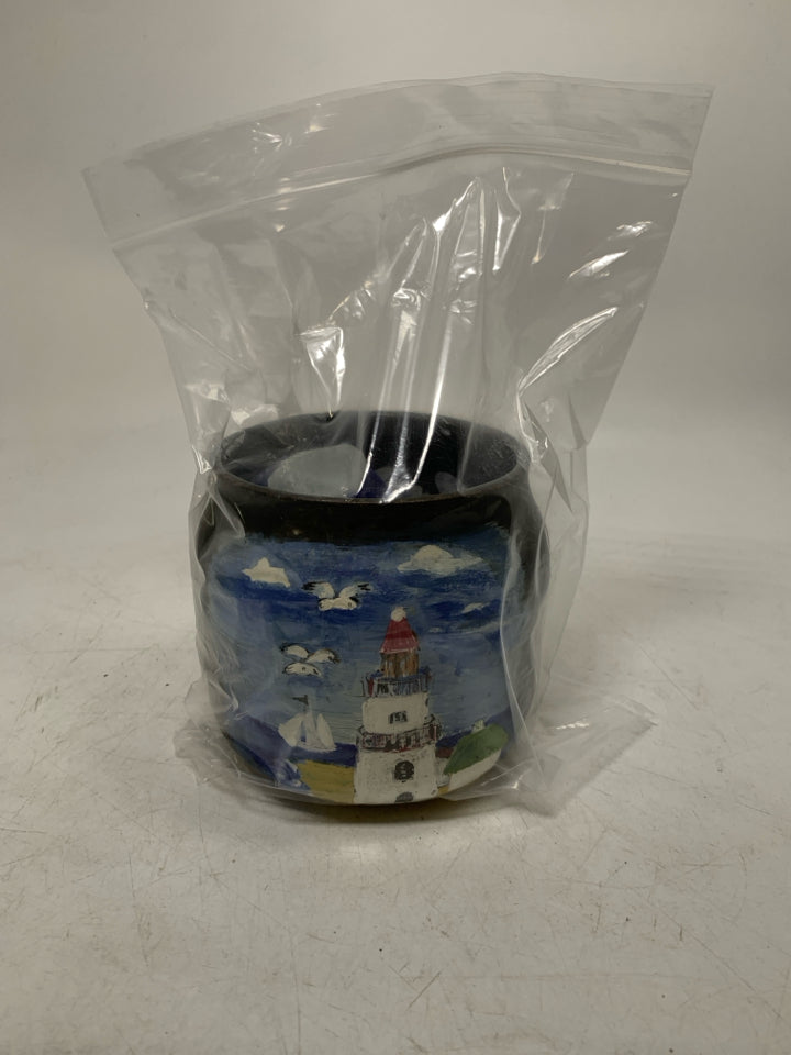 DARK PLANTER W/ PAINTED LIGHT HOUSE FILLER W/ SEA GLASS IN BAG.