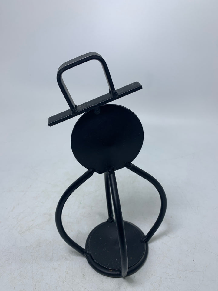BLACK METAL SNOWMAN SMOKING A PIPE TEALIGHT HOLDER.