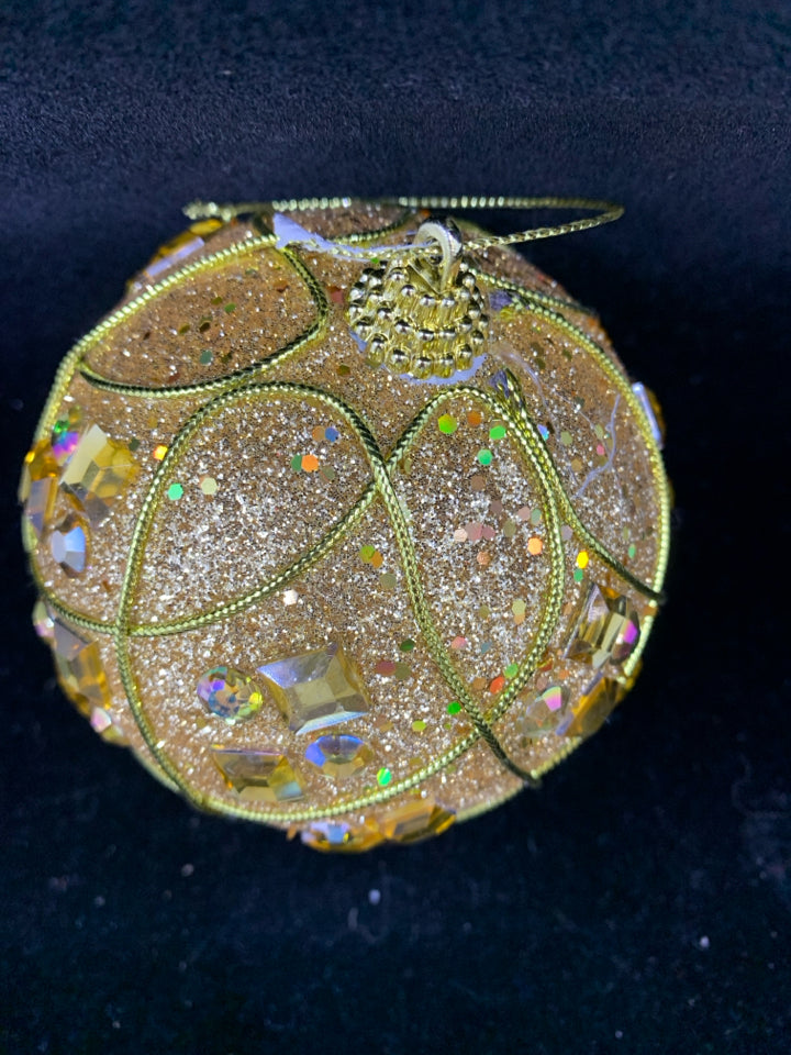GOLD GLITTER PLASTIC ORNAMENT.