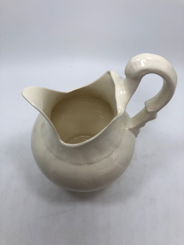 ABSTRACT CREAM COLORED PITCHER.